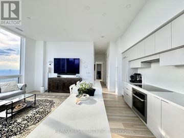 Toronto (Mount Pleasant West) condo for rent - A modern living room with a large television and a view of the mountains.