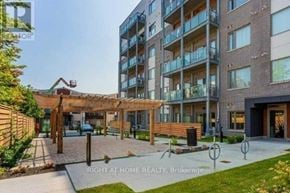 Toronto (Malvern) condo for rent - A modern apartment complex with a covered outdoor seating area.