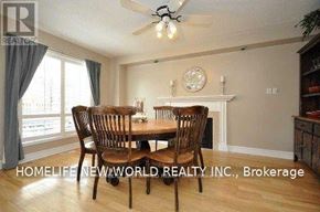Oshawa (Eastdale) apartment for rent - A dining room with a fireplace and a ceiling fan.