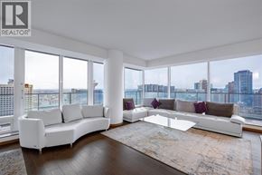 Vancouver apartment for rent - A living room with a white sofa and a glass coffee table.