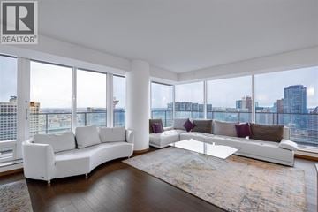 Vancouver apartment for rent - A living room with a white sofa and a glass coffee table.