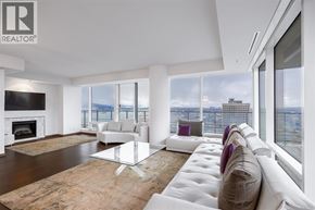 Vancouver apartment for rent - A living room with a fireplace and a couch.