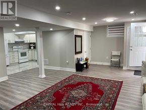 Toronto (Highland Creek) apartment for rent - A living room with a rug in the middle and a kitchen in the background.