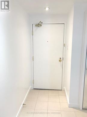 Toronto (Church-Yonge Corridor) condo for rent - A white door in a room with a light switch on the wall.