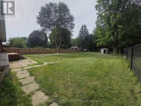 Clarington (Courtice) apartment for rent - A backyard with a fence and a shed.