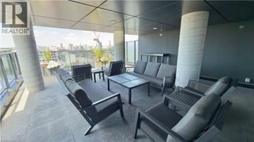 Toronto condo for rent - A modern living room with black furniture and a view of the city.