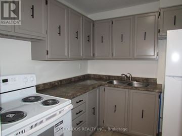 Mississauga (Clarkson) townhouse for rent - A kitchen with a white stove and cabinets.