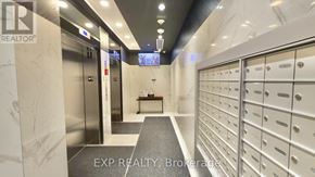 Toronto (Waterfront Communities) condo for rent - A hallway with a row of mailboxes on the right and a bench in the middle.