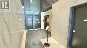Toronto (Waterfront Communities) condo for rent - A hallway with a sign that says EXP REALTY Brokerage.