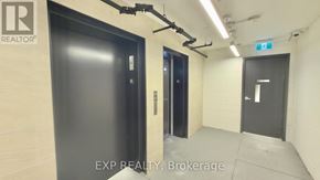 Toronto (Waterfront Communities) condo for rent - A hallway with two doors and a brokerage sign.