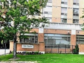 Toronto (Steeles) condo for rent - A building with a sign that says Villa Esplanade in front of it.