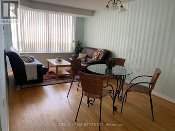 Toronto (Steeles) condo for rent - A living room with a glass table and chairs.