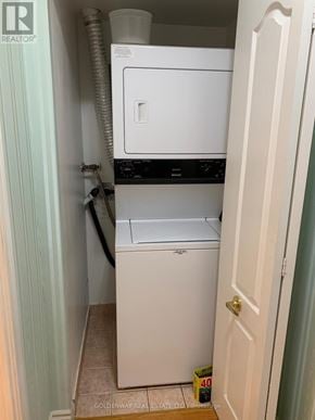 Toronto (Steeles) condo for rent - A white dishwasher and washing machine in a small laundry room.