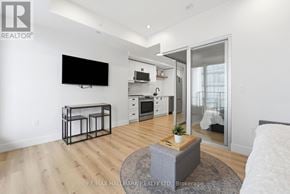 Kitchener condo for rent - A modern living room with a flat screen TV mounted on the wall.