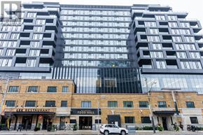 Toronto (Waterfront Communities) condo for rent - A modern building with a glass facade and a brown building with Lee Restaurant on the ground floor.