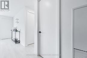 Toronto (Waterfront Communities) condo for rent - A white hallway with a door and a vase on a table.