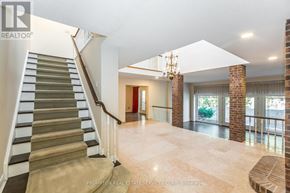 Toronto (Banbury-Don Mills) apartment for rent - A spacious living room with a staircase on the left side and a chandelier hanging from the ceiling.
