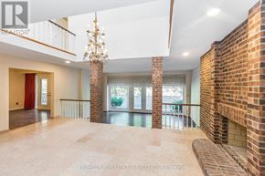 Toronto (Banbury-Don Mills) apartment for rent - A large, empty room with a chandelier and brick walls.