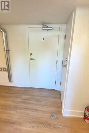 Toronto (East York) multi-family for rent - A white door with the number 9 on it is in a room with a white wall and a wooden floor.