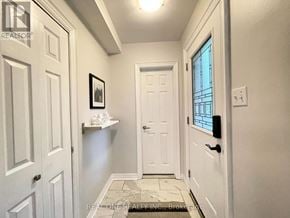 Waterloo townhouse for rent - A hallway with white doors and a tiled floor.