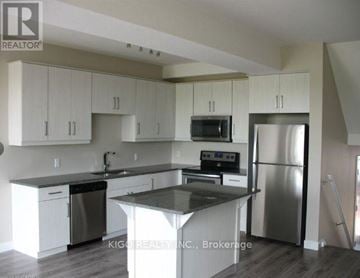 London North (North M) house for rent - A kitchen with white cabinets and a black countertop.