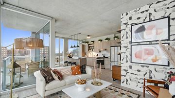 Evanston apartment for rent - A modern living room with a white couch and a glass table.