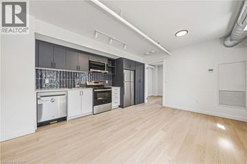 Hamilton apartment for rent - A kitchen with white cabinets and a wooden floor.