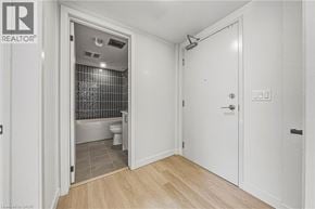 Hamilton apartment for rent - A bathroom with a toilet and a shower is visible from a hallway.