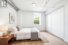 Hamilton (Corktown) multi-family for rent - A bedroom with a bed, nightstand, and window.