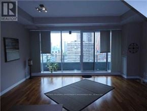 Toronto (Bay Street Corridor) condo for rent - A living room with a large window and a view of the city.