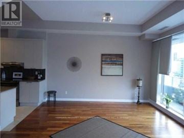 Toronto (Bay Street Corridor) condo for rent - A living room with a grey rug in the middle of the wooden floor.