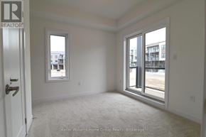 Guelph (Pineridge/Westminster Woods) townhouse for rent - A room with a door, window, and carpeted floor.