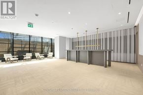 Mississauga (City Centre) condo for rent - A spacious office area with a glass wall and a long table with chairs.
