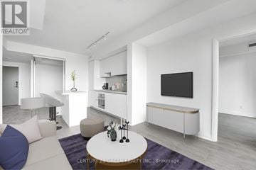 Mississauga (City Centre) condo for rent - A modern living room with a white couch and a flat screen TV mounted on the wall.