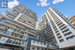 Burlington (Freeman) condo for rent - Two modern buildings with balconies and glass windows are seen from below.