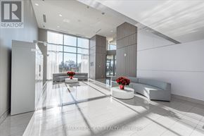 Burlington (Freeman) condo for rent - A modern office lobby with a large window and a bench.