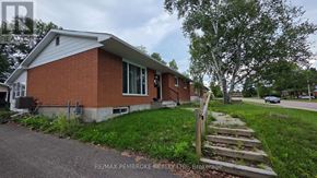 Petawawa apartment for rent - A house with a red brick exterior and a white roof is shown.