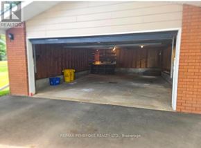 Petawawa apartment for rent - A garage with a white door and a brick wall.