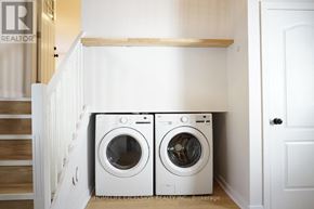 Ramara apartment for rent - Two white front loading washing machines in a laundry room.