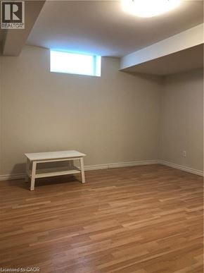 Hamilton apartment for rent - A room with a wooden floor and a white table.
