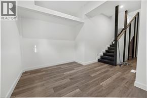 Brantford apartment for rent - A room with wooden flooring and a staircase.