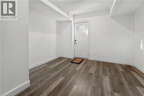 Brantford apartment for rent - A room with a wooden floor and a white door.