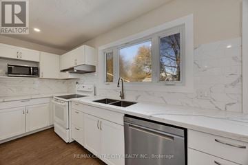 London South (South E) apartment for rent - A kitchen with white cabinets and a marble backsplash.