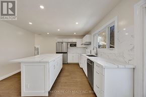 London South (South E) apartment for rent - A white kitchen with a refrigerator, microwave, and oven.