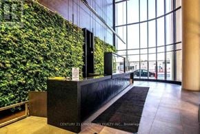 Toronto (Waterfront Communities) condo for rent - A reception area with a green wall and a black reception desk.