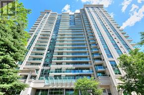 Toronto (Willowdale East) condo for rent - A tall residential building with balconies and a green tree in front.