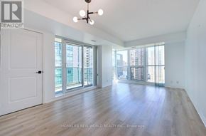 Toronto (Willowdale East) condo for rent - A spacious room with wooden floors and large windows overlooking a cityscape.