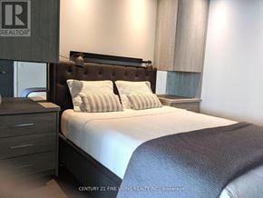 Toronto (Church-Yonge Corridor) condo for rent - A bedroom with a bed, nightstand, and a logo that reads REALTOR.