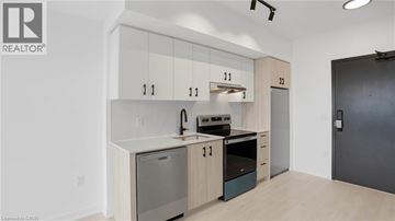 Burlington condo for rent - A modern kitchen with wooden cabinets and stainless steel appliances.