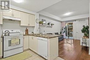 Guelph (Kortright East) condo for rent - A kitchen with white appliances and wooden floors.